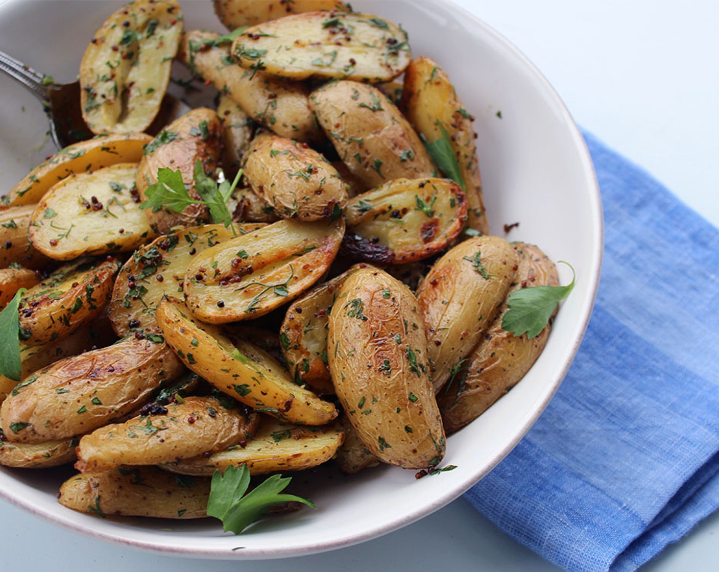 step 4 In a small bowl, whisk together the Fresh Dill (2 Tbsp), Fresh Parsley (2 Tbsp), White Wine Vinegar (1 Tbsp), Olive Oil (1 Tbsp), and Kosher Salt (1/2 tsp). Pour the dressing over the hot potatoes, toss, and serve hot, warm, or at room temperature.