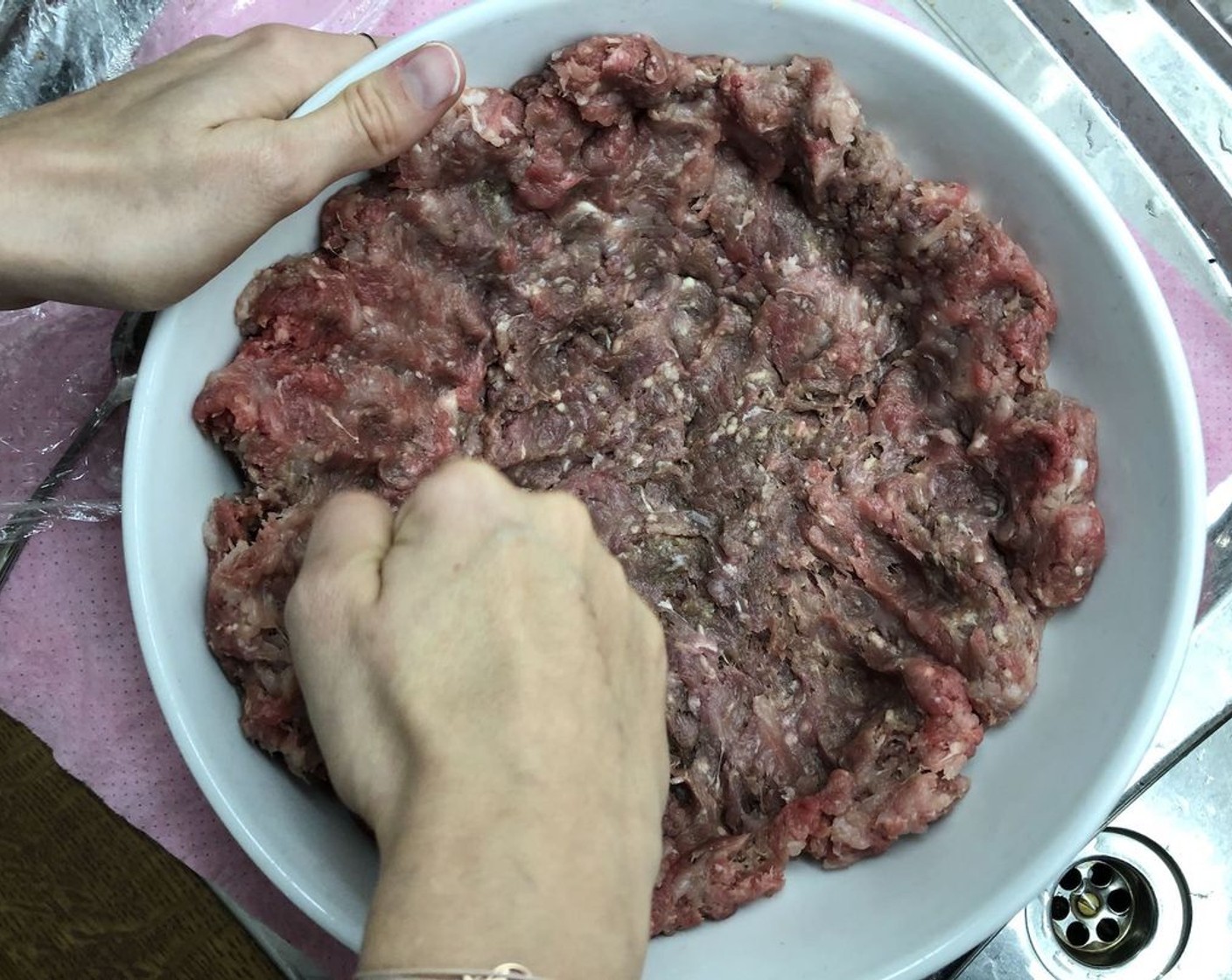 step 7 In a separate bowl, prepare the Ground Beef (1.5 lb) by flattening it with the balls of your fist.