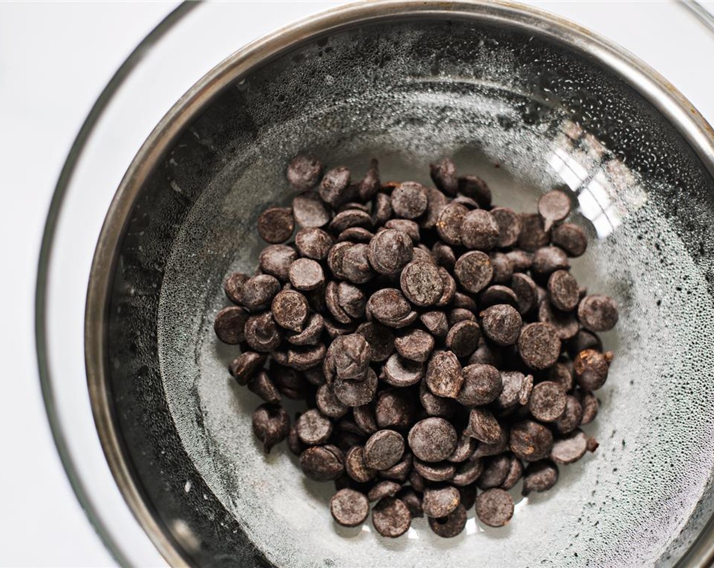 step 2 Fill a saucepan with about three inches of water, and set to boil. Once boiling, place a large bowl on top (not touching the water), and add Dark Chocolate (1/2 cup).