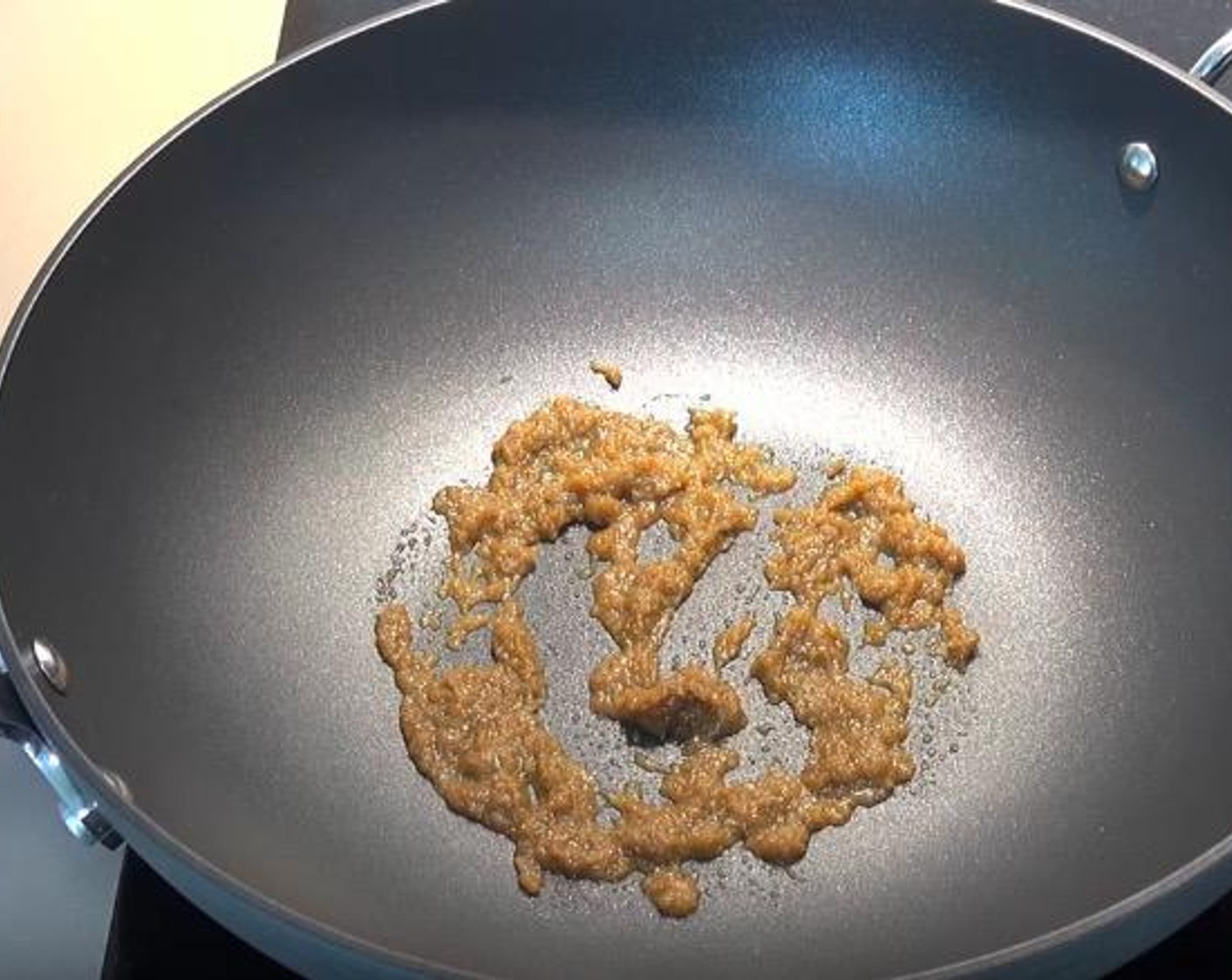 step 1 In a wok, add Thai Green Curry Paste (1 Tbsp). Stir on medium-high heat until fragrant and bubbling slightly.