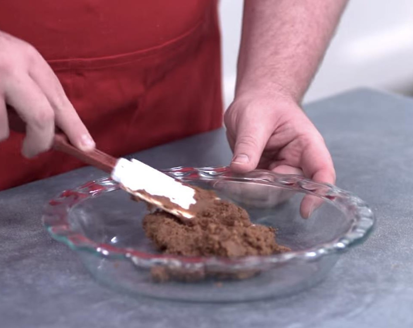 step 3 Transfer wet cookie mixture into a large pie plate and spread it out over the bottom and sides.