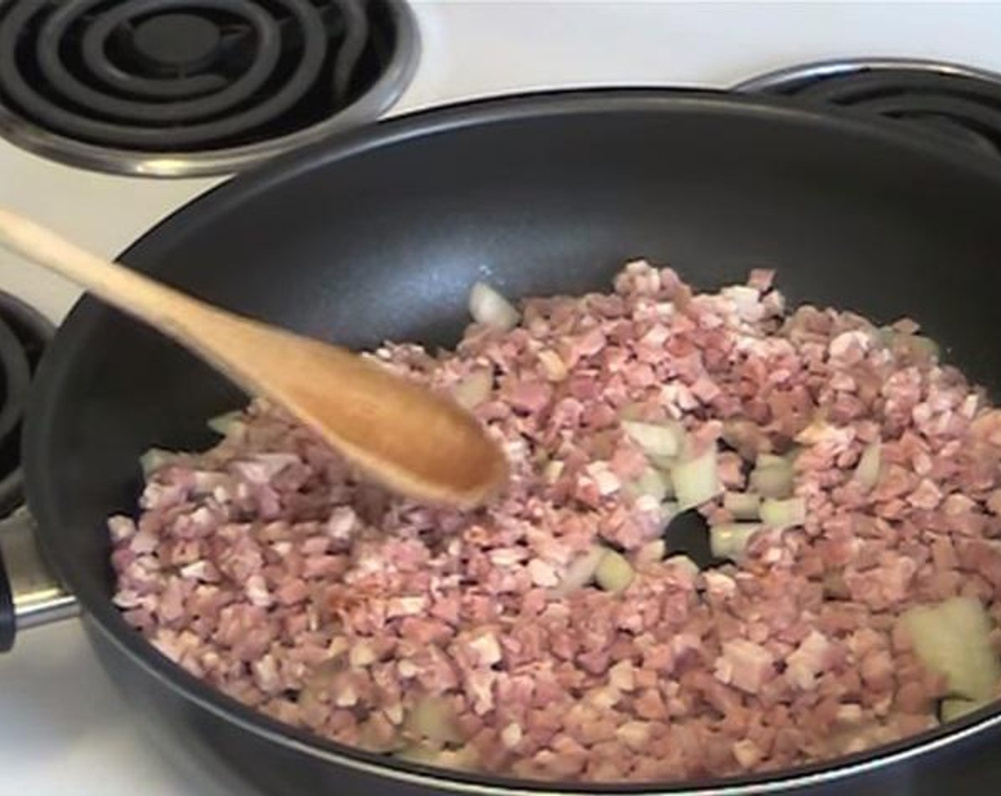 step 2 Inside a greased pan, fry together the Yellow Onion (1), and Diced Bacon (1.1 lb) for about 3 minutes.