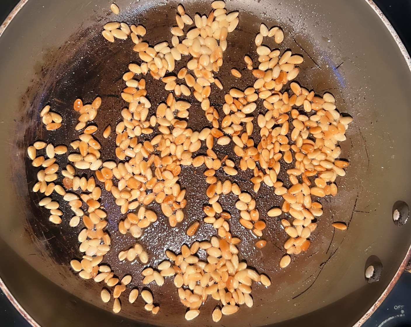 step 3 Heat 1 Tbsp of Olive Oil (1 Tbsp) on a skillet and toast the Pine Nuts (1/2 cup) until golden brown. Transfer to a bowl and set aside.