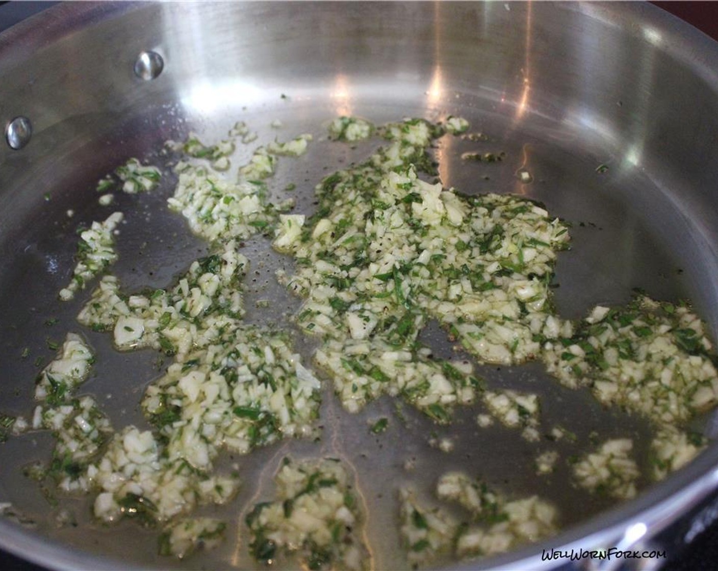 step 3 Heat Olive Oil (2 Tbsp) in a large saute pan. Add Fresh Basil (2 Tbsp), Fresh Rosemary (1 Tbsp), and Garlic (3 cloves) to the pan with Salt (to taste) and Ground Black Pepper (to taste). Cook for about one minute.