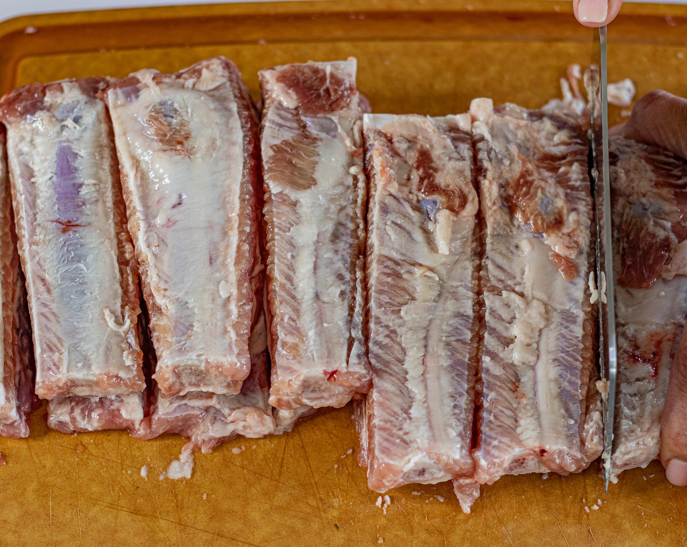 step 3 Once done, slice off each rib and place it in a bowl. Rinse well with water and drain.