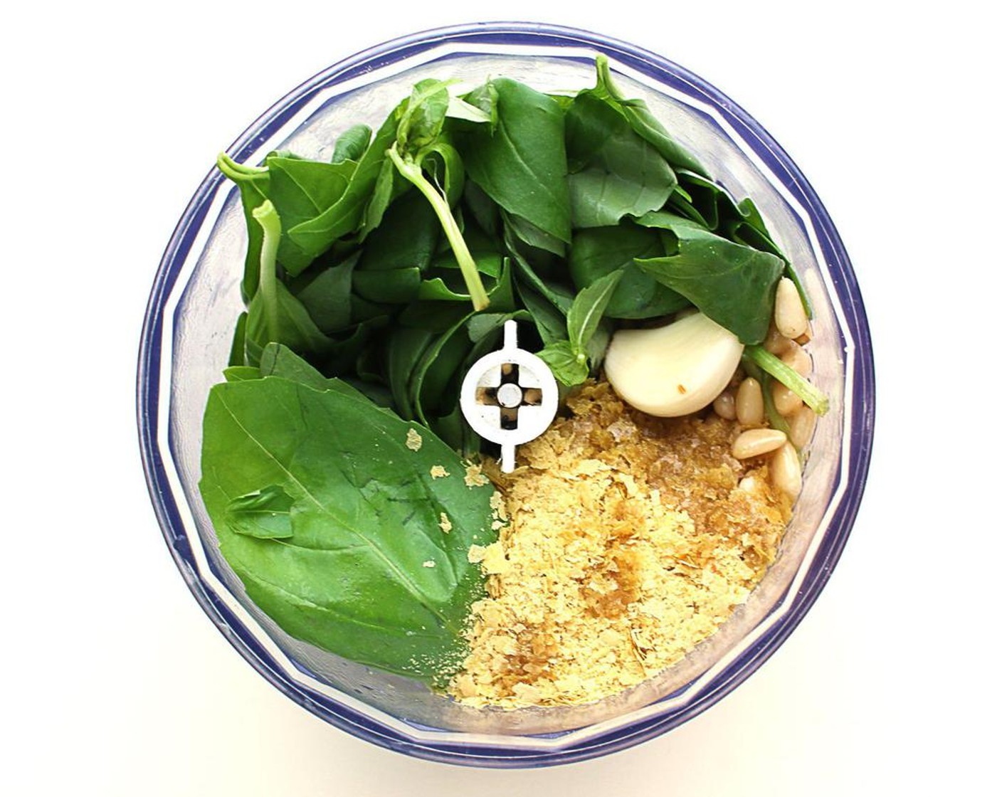 step 1 Add Fresh Basil (3 cups), Pine Nuts (1/3 cup), Nutritional Yeast (3 Tbsp), Olive Oil (1/4 cup), Garlic (1 clove), the juice from Lemon (1), Salt (1/4 tsp) to a small food processor or blender.