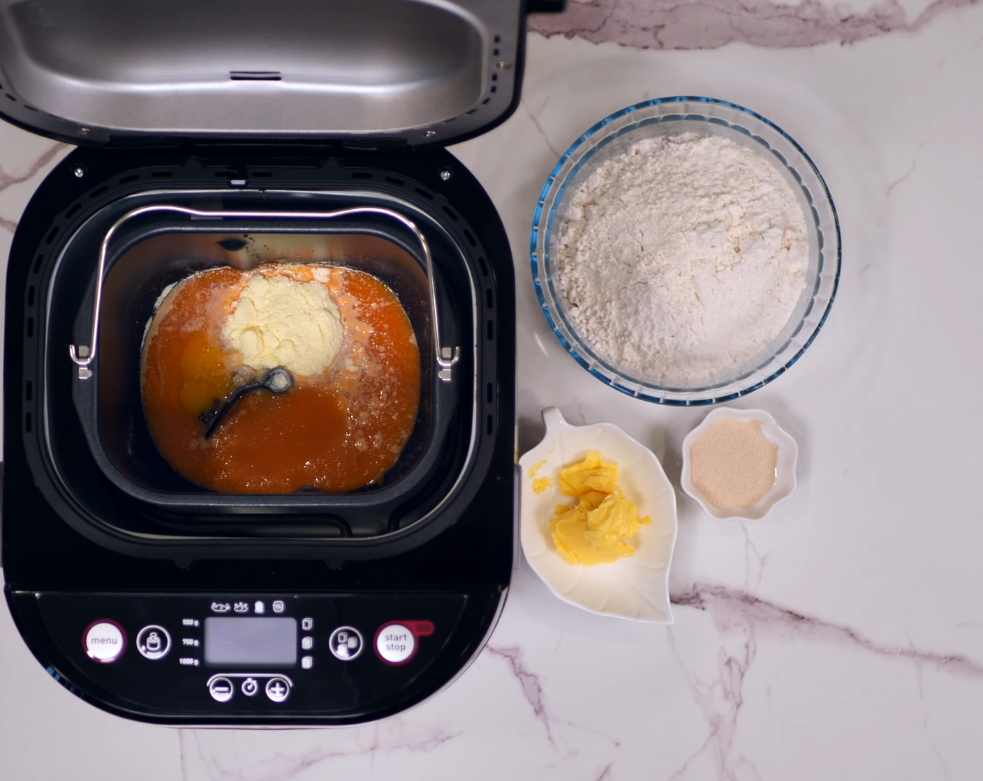 step 2 Place the pumpkin and carrot juice mixture, Egg (1), Milk Powder (2 Tbsp), Granulated Sugar (2 Tbsp), Bread Flour (2 1/3 cups), Instant Dry Yeast (1 1/2 tsp), and Salted Butter (2 Tbsp) into a breadmaker.