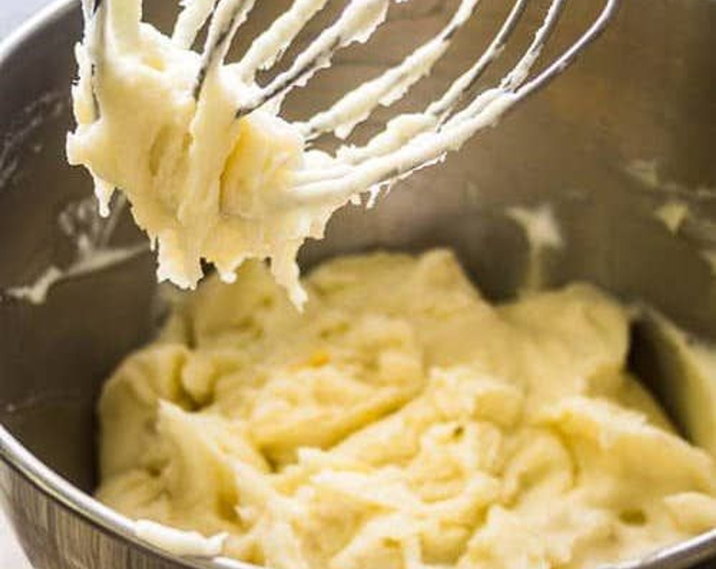 step 5 Slowly add milk mixture to potatoes. Once liquid has been added, speed up mixer and beat potatoes until creamy texture is achieved.