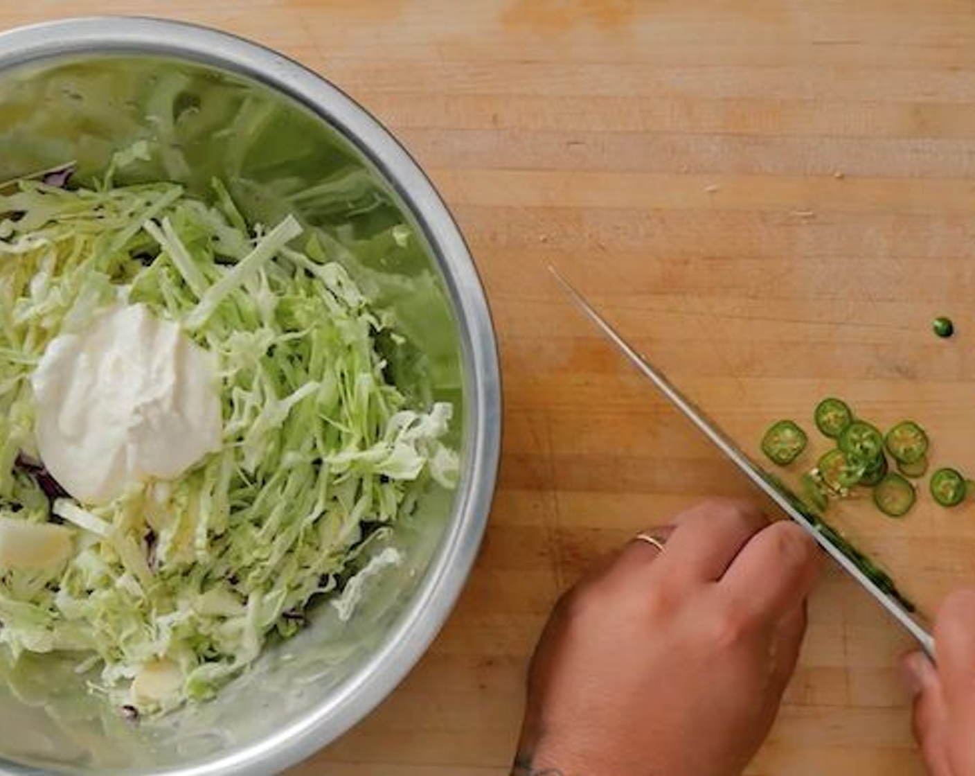 step 3 Shred the Red Cabbage (1/2) and Green Cabbage (1/2). Slice the Serrano Chili (1). Toss both cabbages and Serrano chili together with Mayonnaise (1 Tbsp), the juice from the Lime (1/2), Salt (to taste), and Ground Black Pepper (to taste).