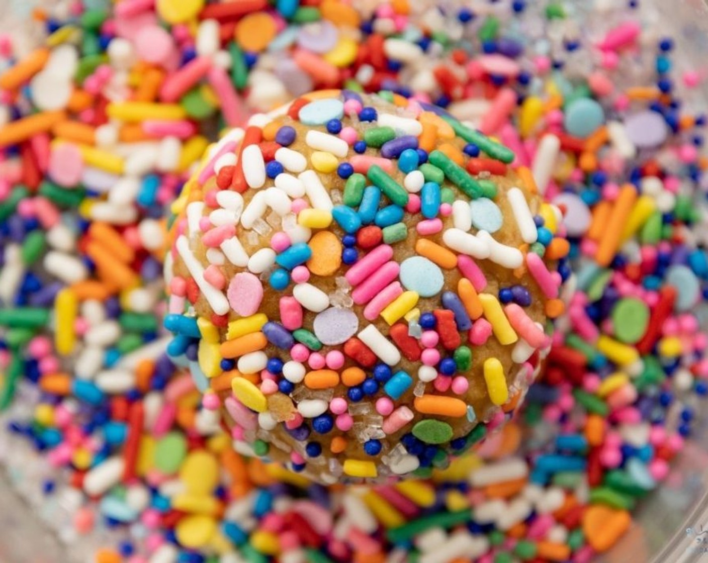 step 7 Roll each cookie dough ball into a bowl of Sprinkles (1/2 cup) until well coated.