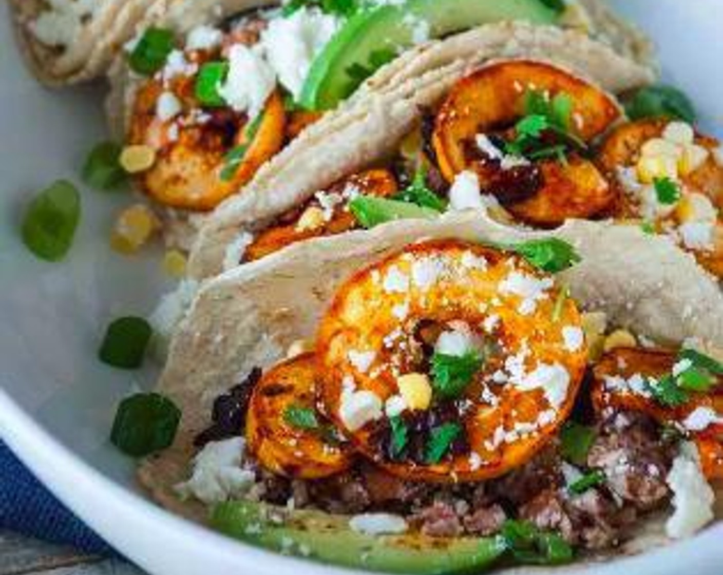 step 5 Assemble the tacos by layering the beans, squash, Corn (1/2 cup), Lime (1), Fresh Cilantro (to taste), Scallions (to taste), Feta Cheese (to taste), and Avocados (to taste) over the Tortillas (8). Enjoy!