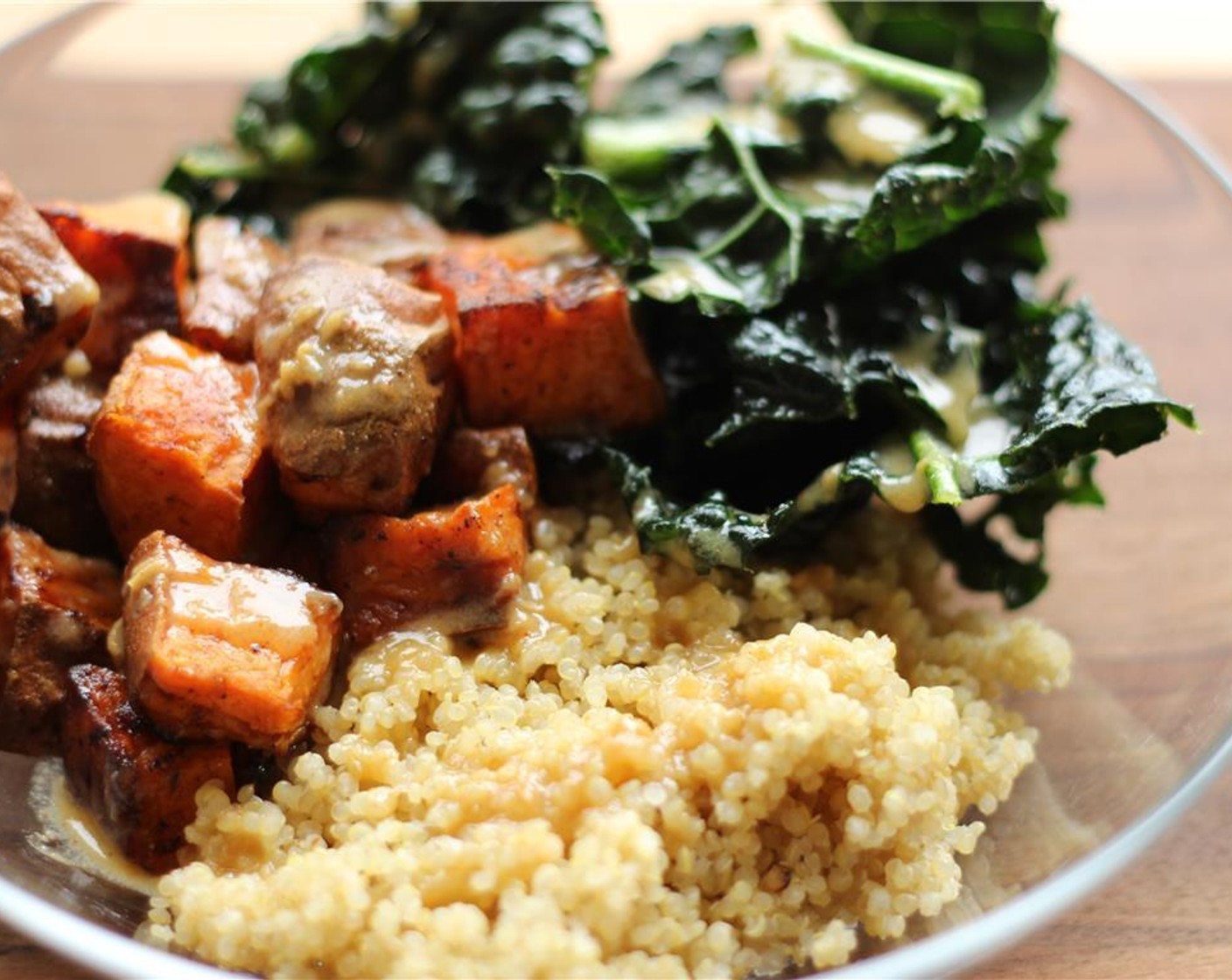 step 4 Layer the bowl with the Quinoa (1 cup), then the marinated kale. Add the Sweet Potatoes (2 cups) and drizzle with 1/4 cup of Tahini Maple Ginger Dressing.