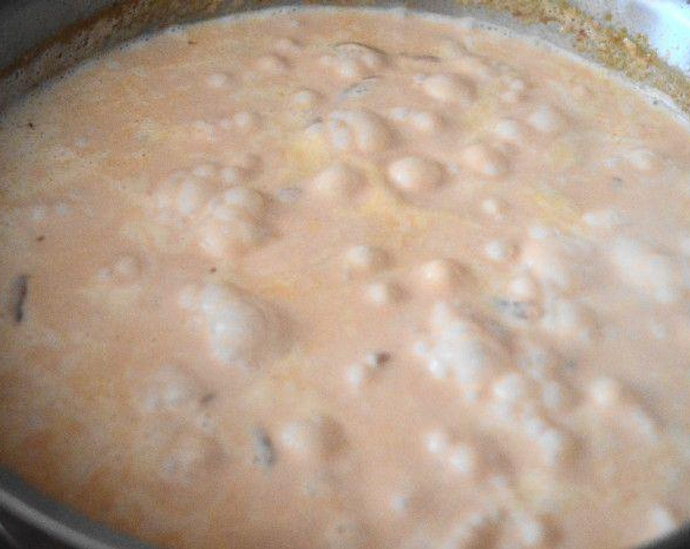 step 4 When the tomato mixture is done simmering, add the Heavy Cream (2 cups), Vodka (4 Tbsp), Salt (1 pinch), and Crushed Red Pepper Flakes (1 pinch).