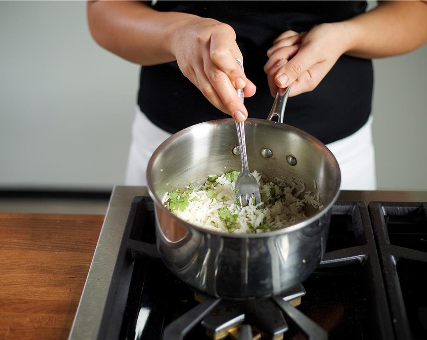 step 8 Remove from heat and let sit, covered for five minutes before fluffing with a fork. Stir in the Butter (1 Tbsp) and nearly all the Cilantro. Set aside.