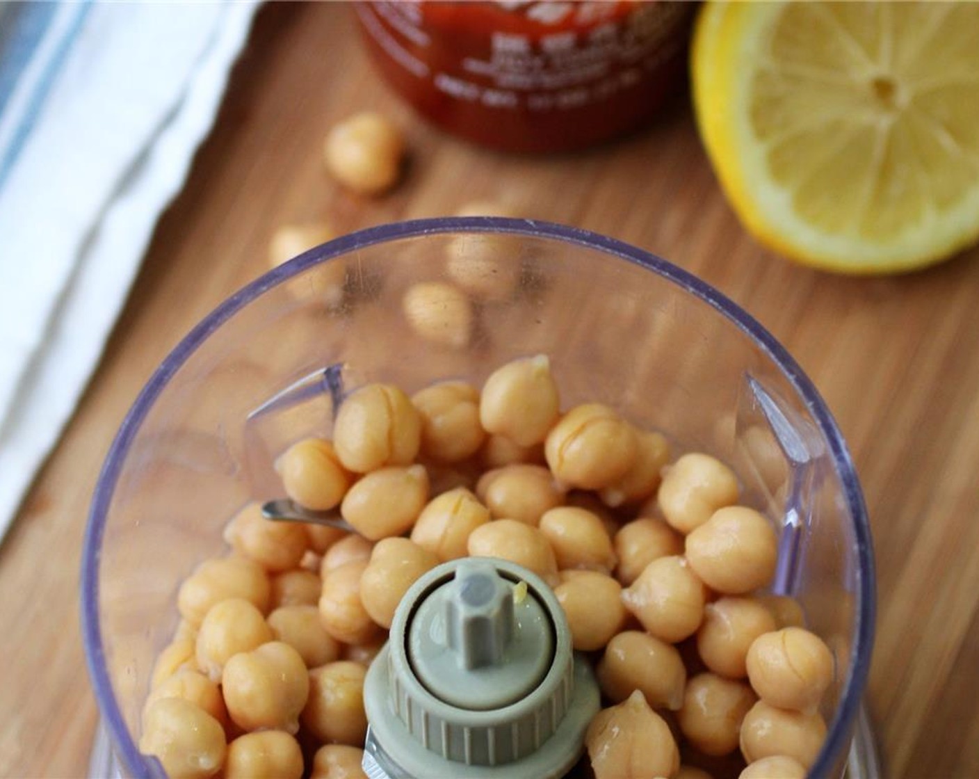 step 1 Juice the Lemon (1/2) and reserve. Drain the Canned Chickpeas (2 cups) and reserve 2 1/2 tablespoons of chickpea can water.