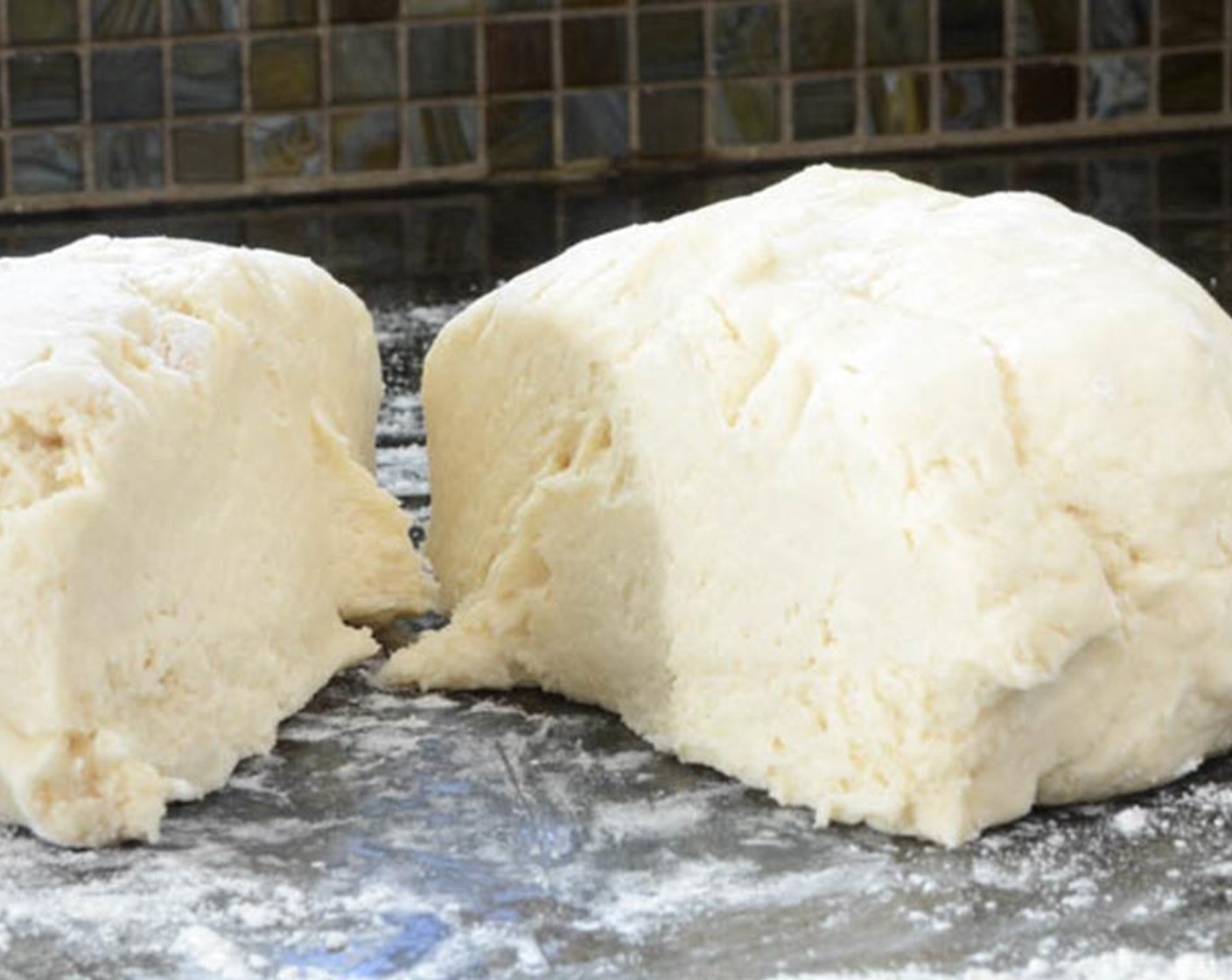 step 4 Turn the dough out onto a lightly floured surface and work it into a ball. Divide the dough into 4 equal pieces and and press each into a rough rectangle shape.