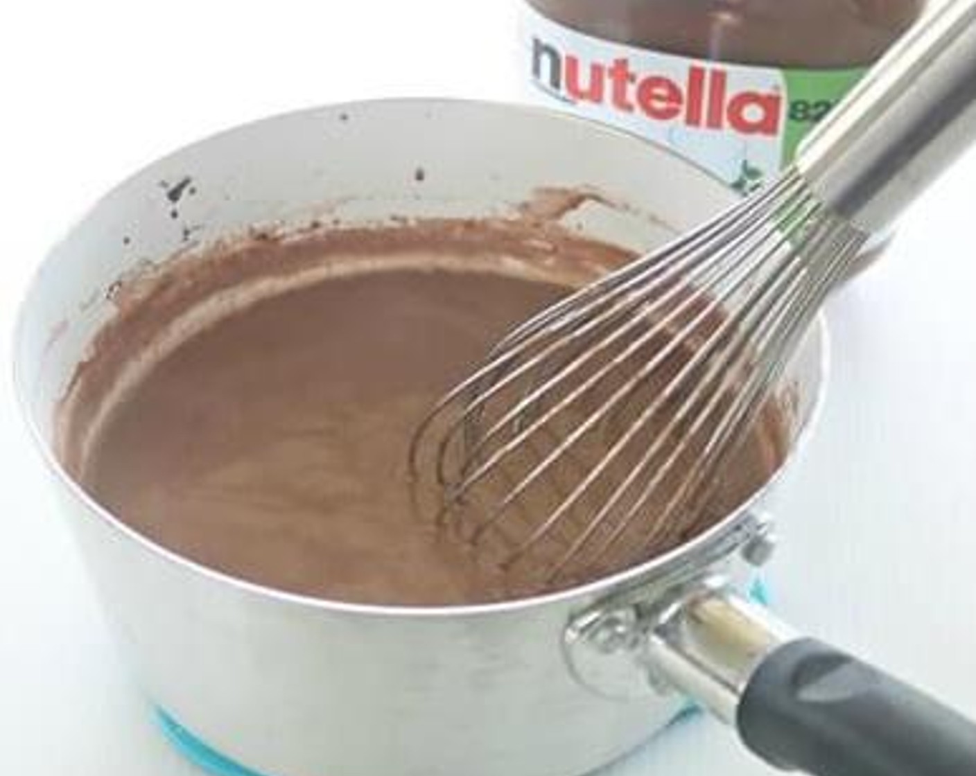 step 3 Soak the Gelatin Sheets (4) into cold water for a few seconds, squeeze out excess water and drop into milk mixture, stir till gelatin melted. Turn off heat and stir in Nutella® (2 Tbsp), stir well again till melted.