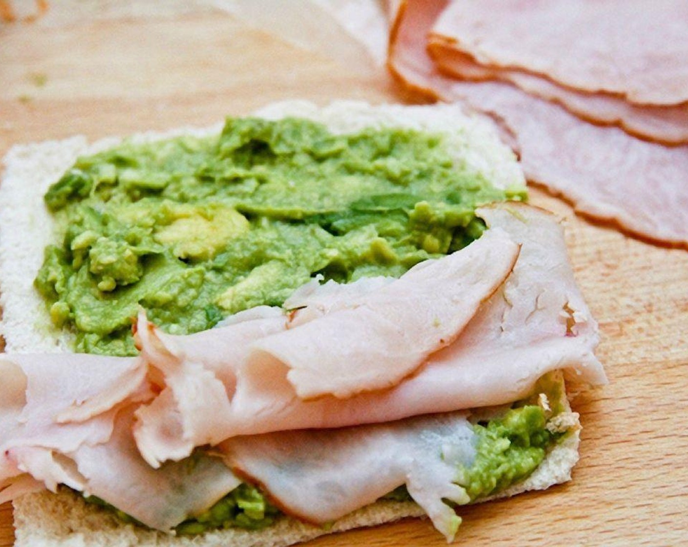 step 6 Spread the avocado onto a slice of bread then top it with Deli Turkey (2 slices).