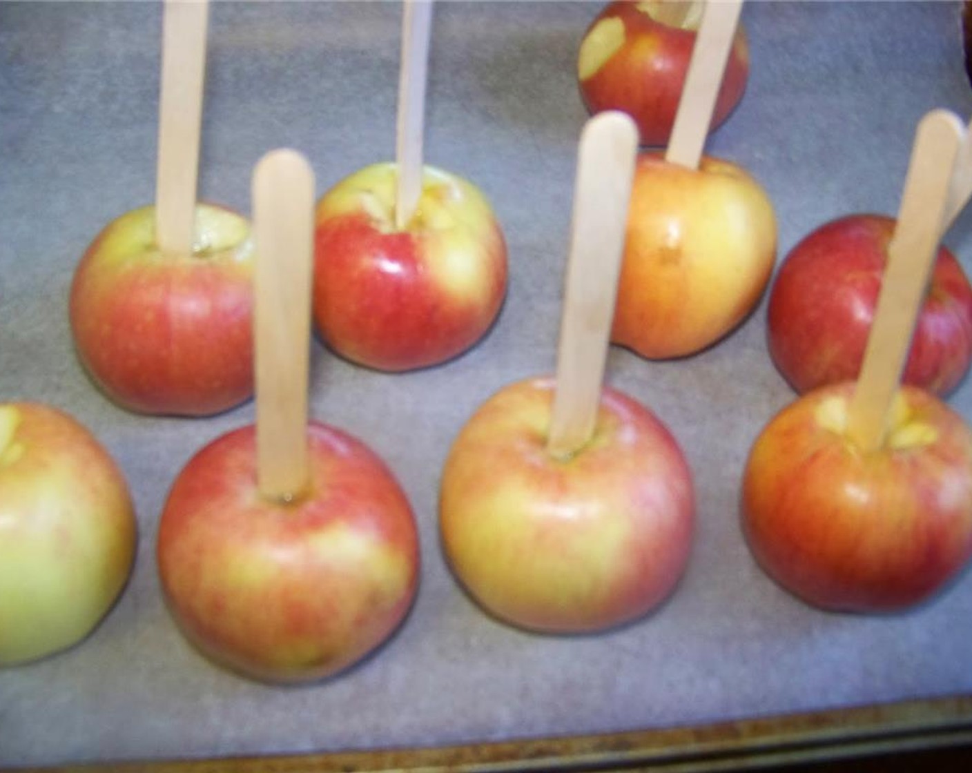 step 2 Wash and remove the stems from the Apples (6). Insert popsicle sticks into the apples and chill them until needed.