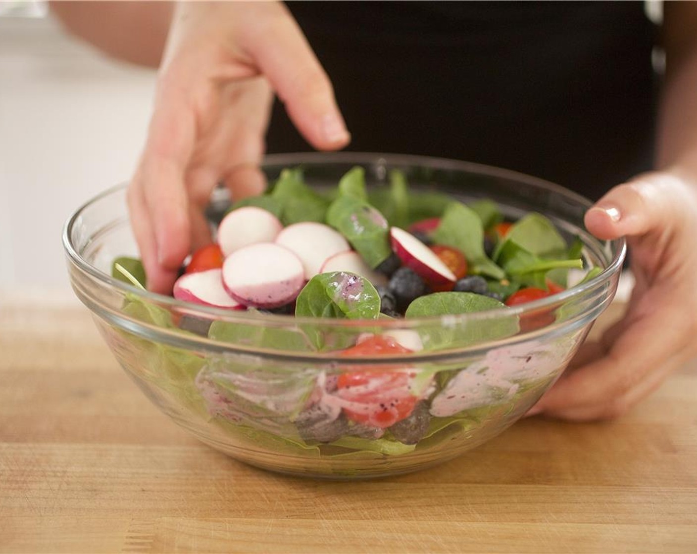 step 7 In a medium bowl, combine Fresh Baby Spinach (3 3/4 cups) red cherry tomatoes , radishes and the remaining blueberries.