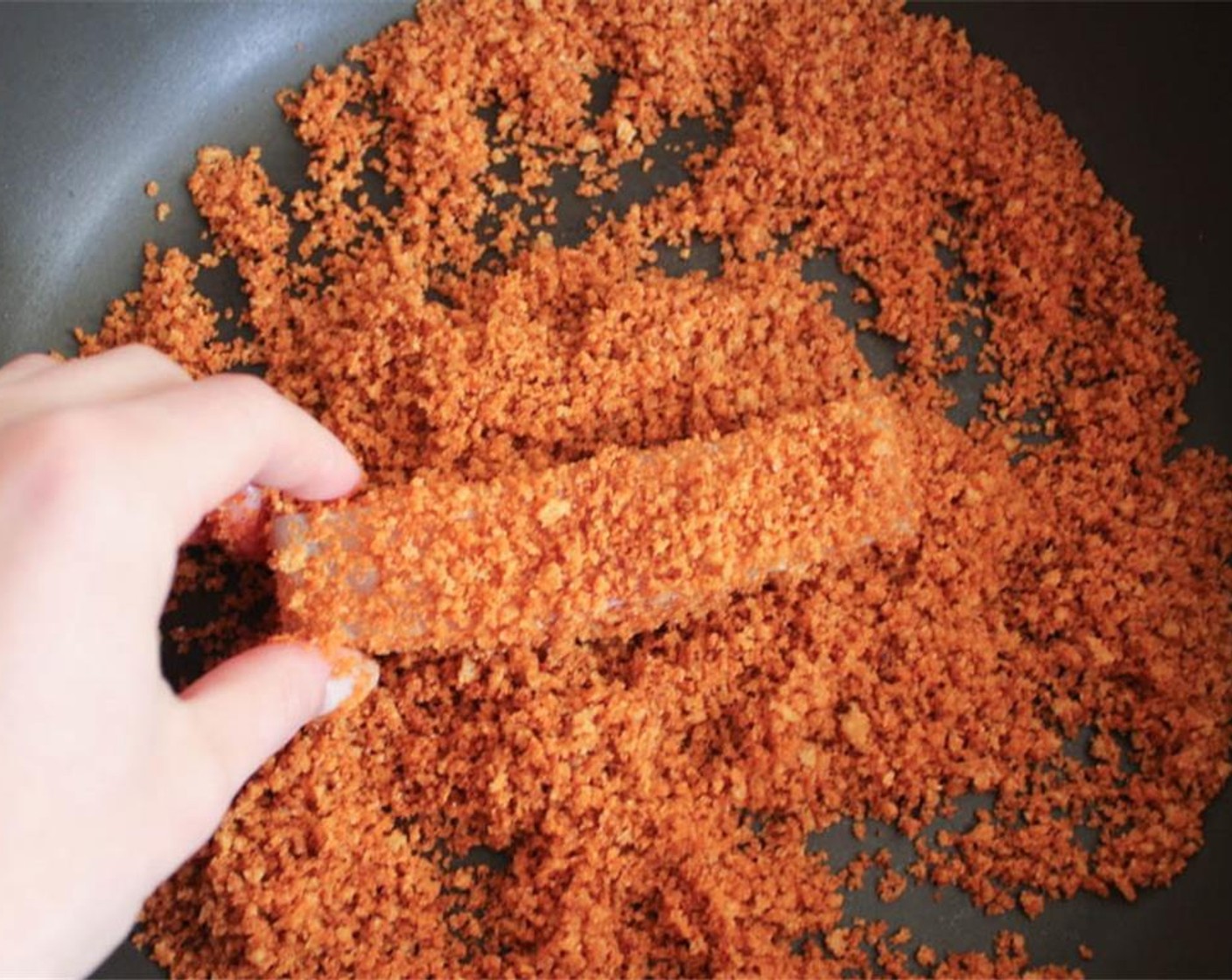 step 14 Shake off any excess, then coat it in the seasoned breadcrumbs, pressing gently to help them adhere.