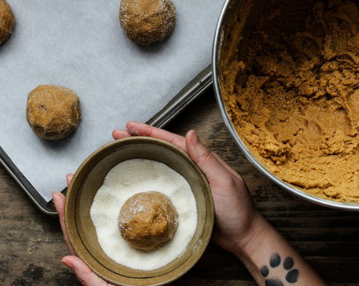 step 8 In a bowl, add in Granulated Sugar (1/4 cup) and roll the cookie dough in it. Use 1 1/2 tablespoon to 2 tablespoon sized dough balls, slightly larger than a golf ball size. If your hands are super warm and are finding the dough tough to work with since it is very soft, try cool your hands down by running cold water on your wrist.