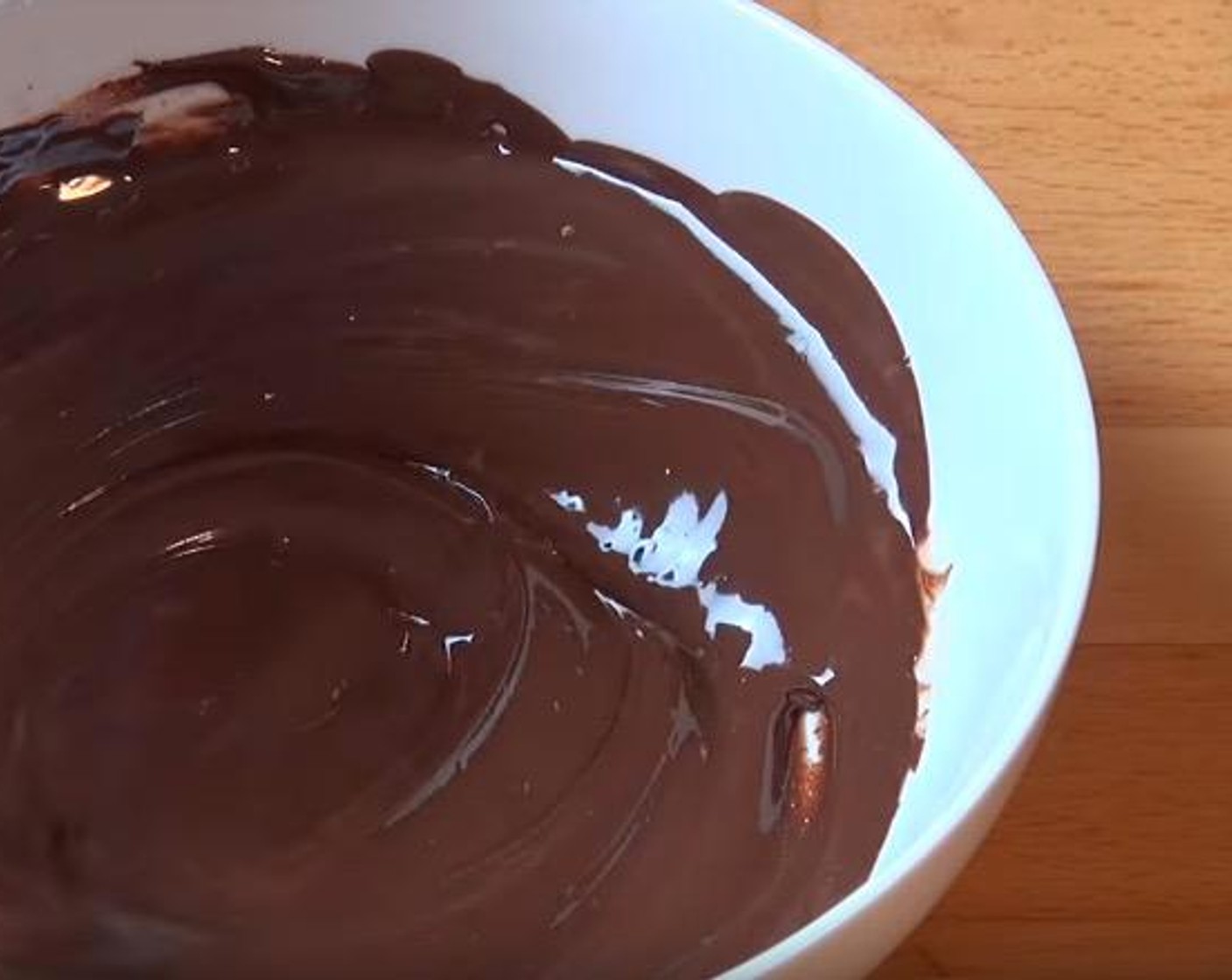 step 6 For the chocolate layer, combine Dark Chocolate (1 cup) and Vegetable Oil (1 Tbsp) in a microwave-safe bowl. Heat for 30 seconds, stir, and repeat until chocolate is melted and smooth.