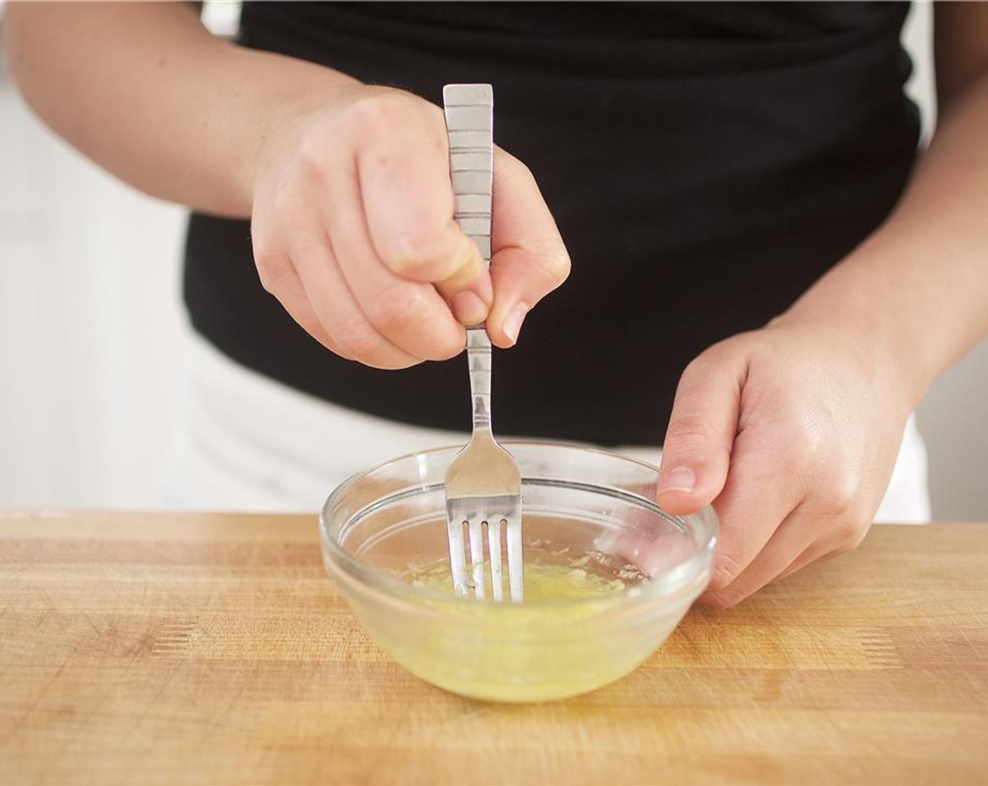 step 7 In the small bowl with the lemon, add garlic, Olive Oil (1 Tbsp), the remaining Champagne Vinegar (1 Tbsp), and Salt (1/2 tsp). Mix until well combined and set aside.