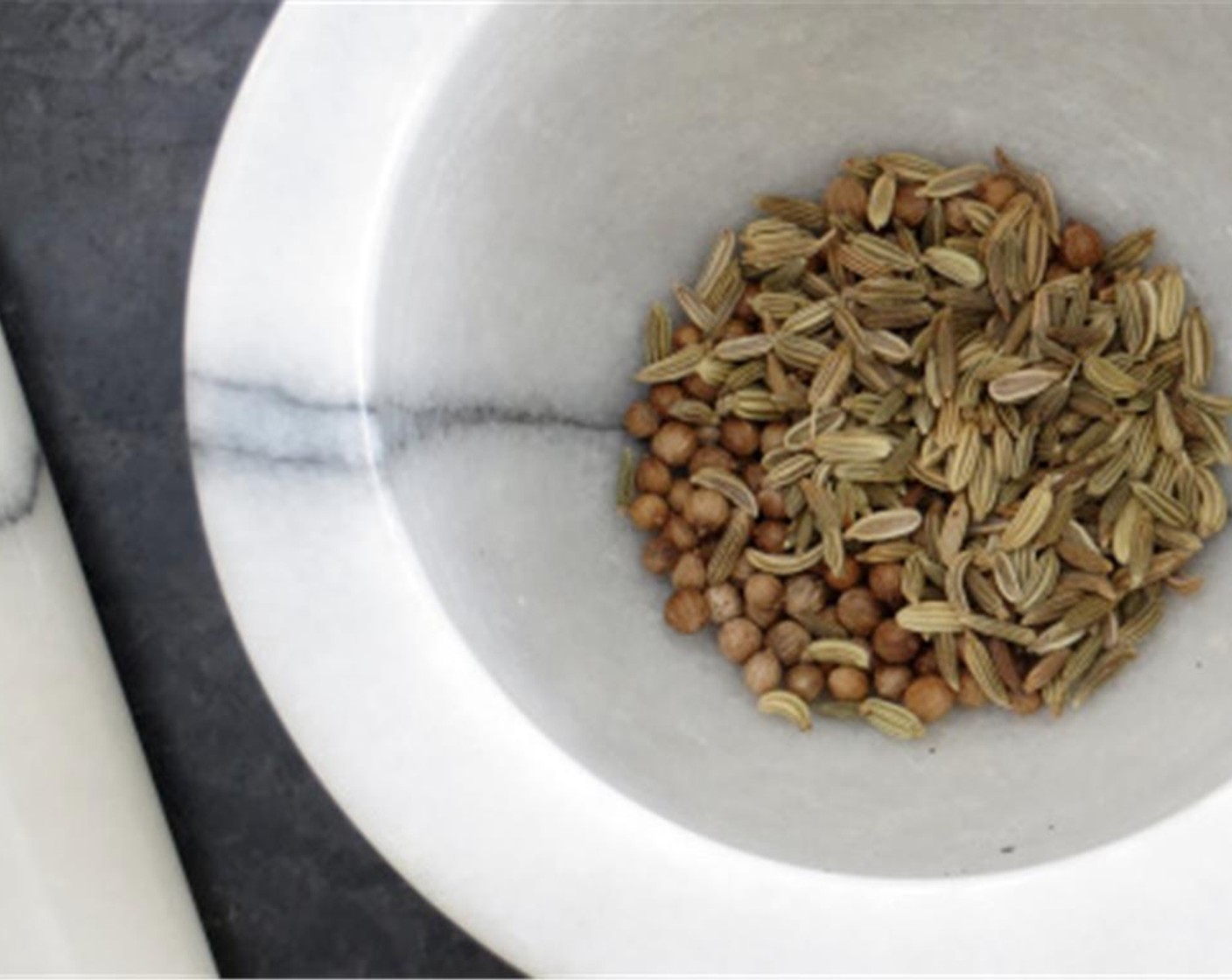 step 5 In a mortar and pestle, grind together the whole Whole Coriander Seeds (1 tsp) and Fennel Seeds (1 tsp) Mix in the Kosher Salt (1/2 tsp), Brown Sugar (1 Tbsp) Stir to combine. Sprinkle the spice blend evenly over squash. Bake 20 minutes.