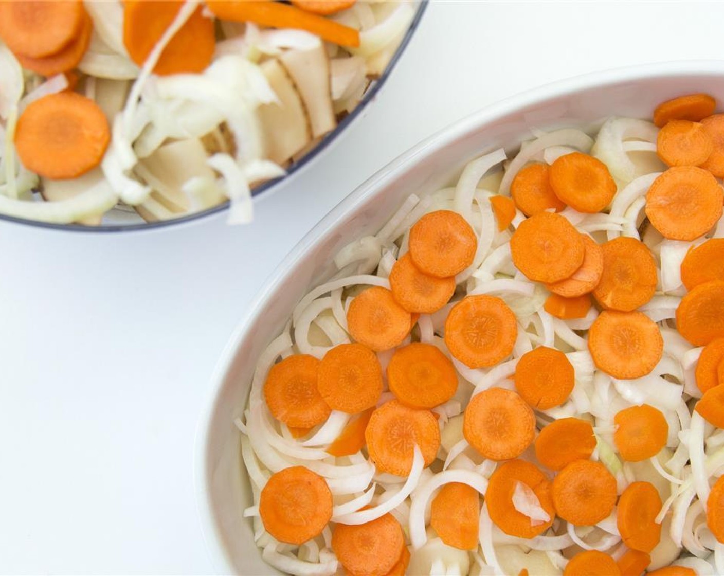 step 4 In a lightly greased 9×13 inch baking dish, layer half the Potatoes (6 cups), Onions (2) and Carrots (4) mixture. Top with half of the cheese sauce.