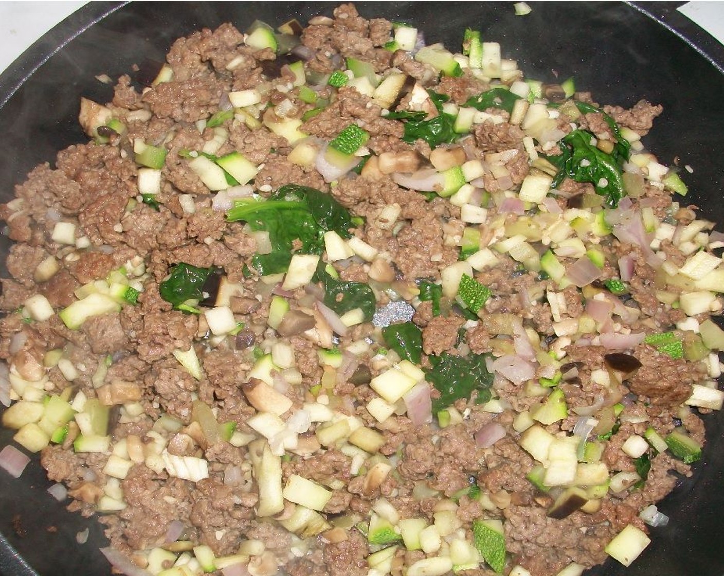 step 2 Brown the Ground Bison (8 oz). Add Zucchini (1/4), Eggplant (1), Onion (1/4), Mushrooms (2), Garlic (1 Tbsp), and Spinach Leaves (1 handful) to the bison. Add the Pasta Sauce (2 1/3 cups) to the mix and cook on medium-low.