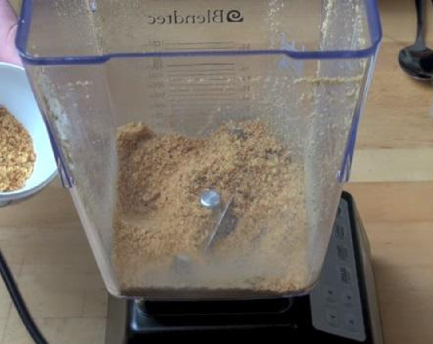step 1 Into a blender, break down the Graham Crackers (6). Then take a couple of teaspoon of the crumbs and set aside for garnishing.