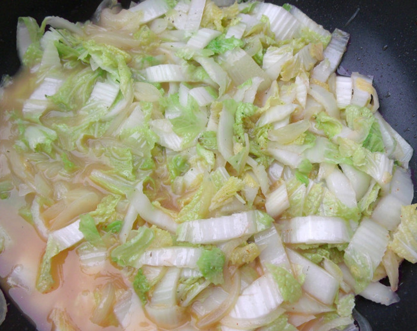 step 9 Add Napa Cabbage (1 head) and Chicken Stock (1 cup). Saute until cabbage wilts.