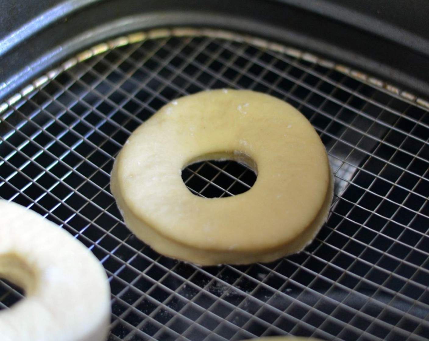 step 6 Heat up your air fryer to 355 degrees F (180 degrees C). Wait a minute, spray with Oil (as needed), then lay donuts gently at the bottom of the basket. Spray donuts with a light mist of oil, too (but that’s optional).