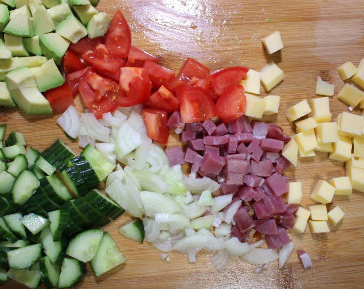 step 2 Dice the Gouda (1 1/4 cups), Smoked Beef (6 oz), Onion (1), Cucumber (1/2), Tomato (1) and Hass Avocado (1) to your preferred size.