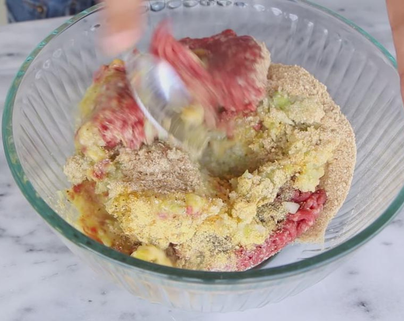 step 2 Add Lean Ground Beef (1 lb), processed vegetables, Breadcrumbs (1/4 cup), Ground Black Pepper (1/4 tsp), Egg (1), Chicken Bouillon Powder (1/2 Tbsp), and Dried Oregano (1/2 tsp) to a bowl. Use a spoon to mix.