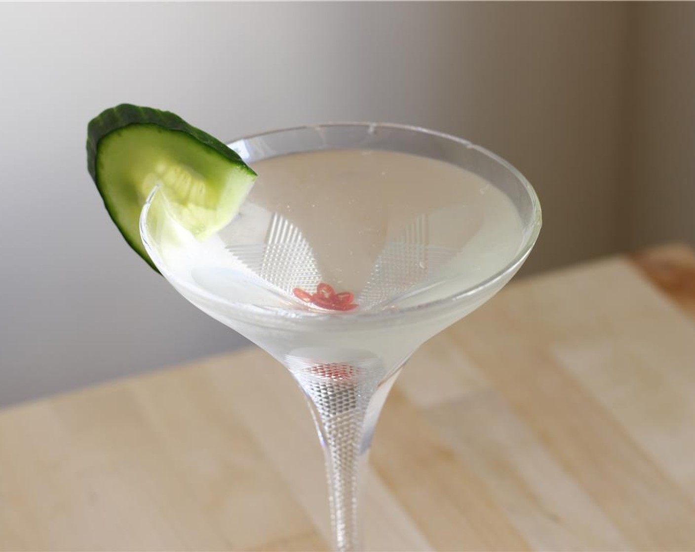 step 5 Strain cocktail into the martini glass, garnish with cucumber, and sip!