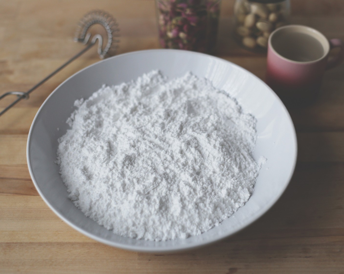 step 18 While doughnuts are cooling, make the glaze by placing the Powdered Confectioners Sugar (1 cup) in a bowl.