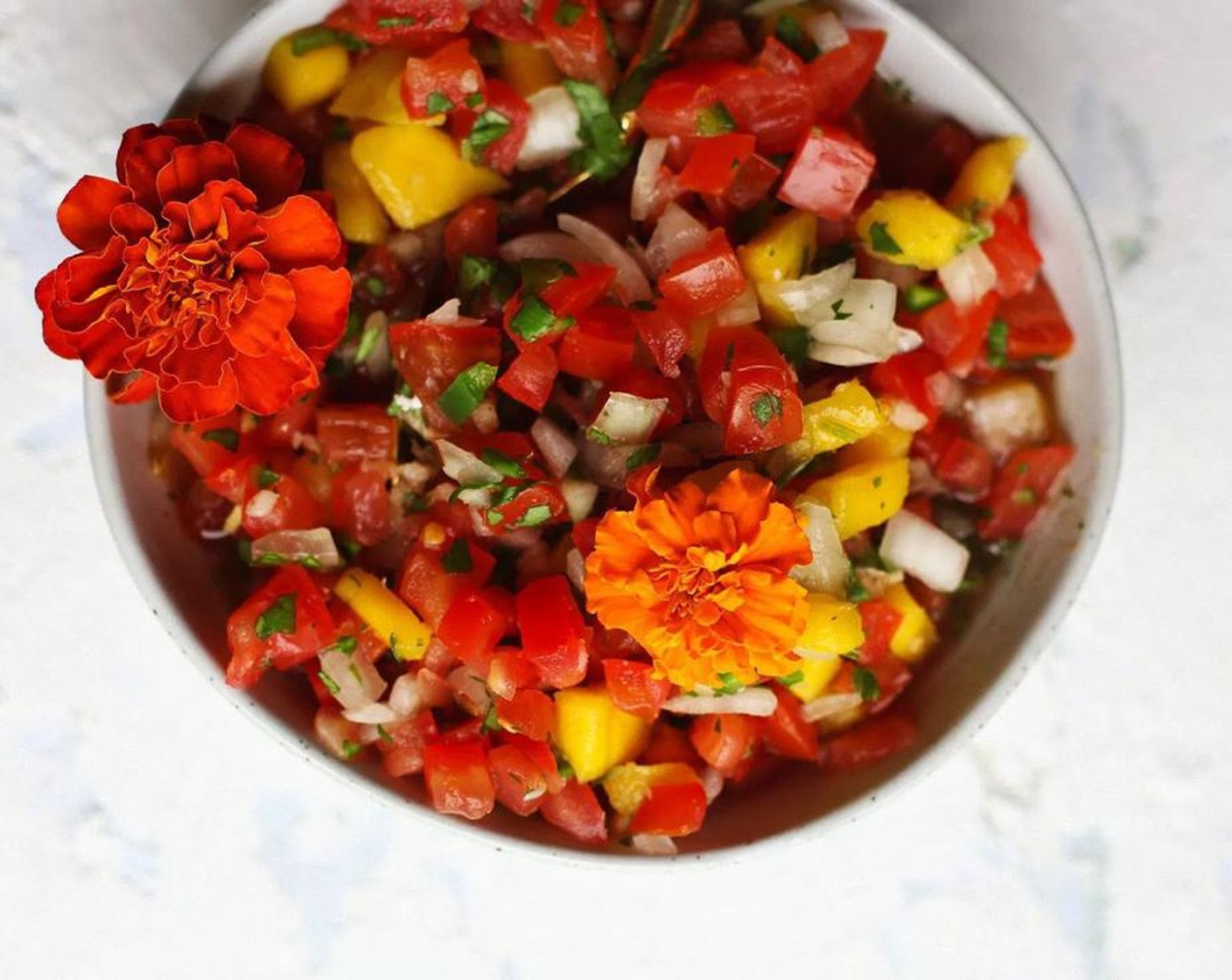 step 5 For the Pico De Gallo: Remove the seeds from Roma Tomatoes (7) and cut into small pieces, and place in medium bowl. Peel the Mango (1) and chop into the same size pieces as the tomatoes.