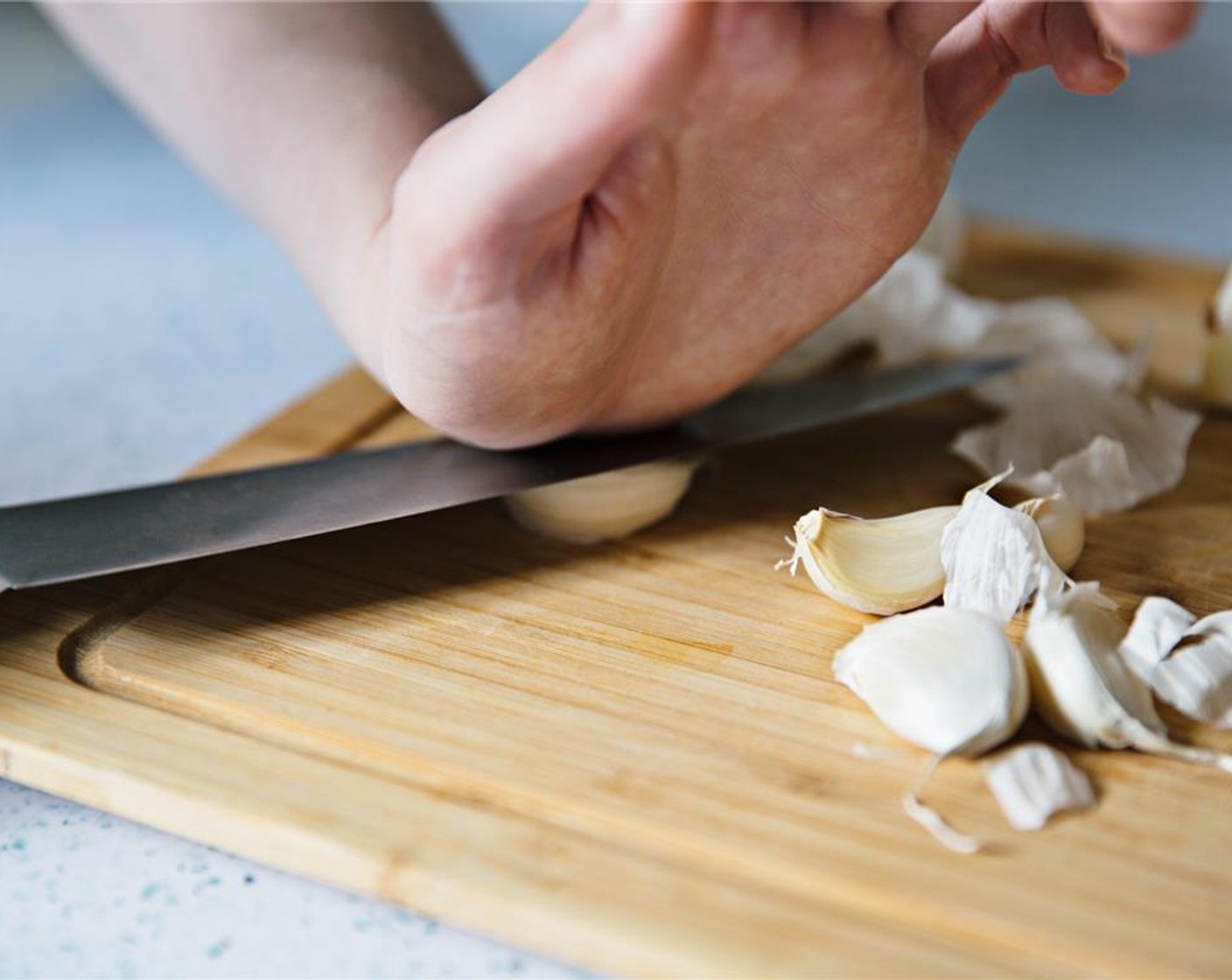 step 4 Peel and crush Garlic (4 cloves) with a knife.