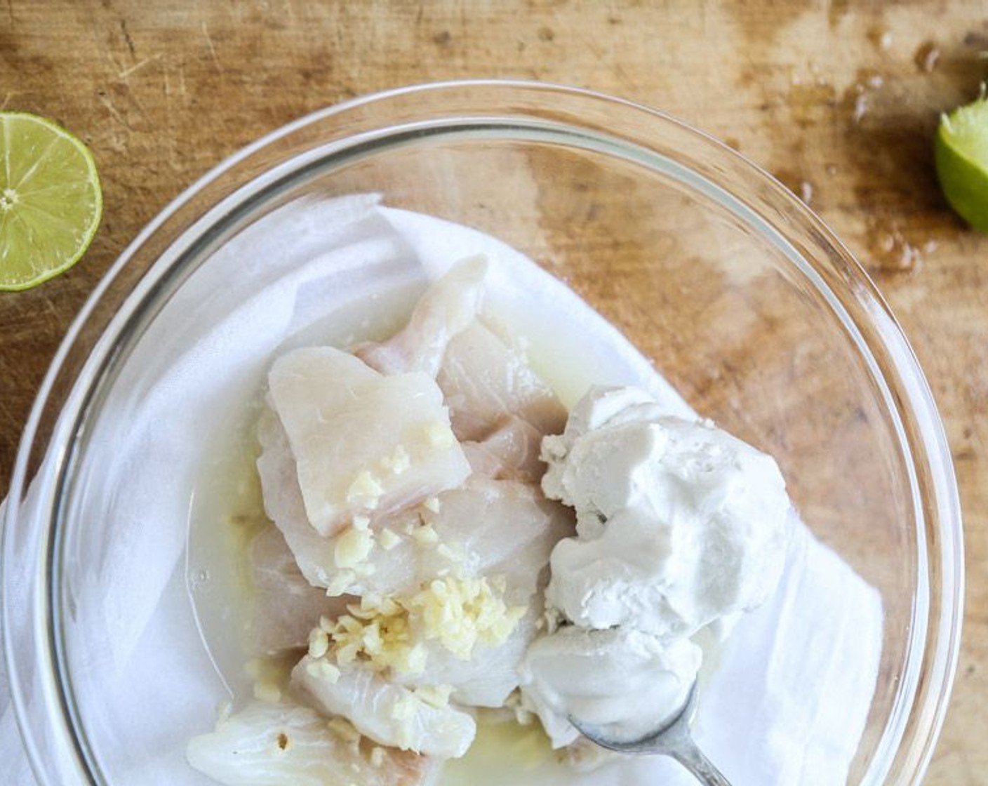 step 2 In a large mixing bowl, toss the Skinless Hake Fillets (1.5 lb) with the Garlic (2 cloves), juice from Limes (3), Coconut Cream (5.4 fl oz), Sea Salt (to taste), and Paprika (1/2 tsp). Marinate the fish while you prepare the remaining ingredients.