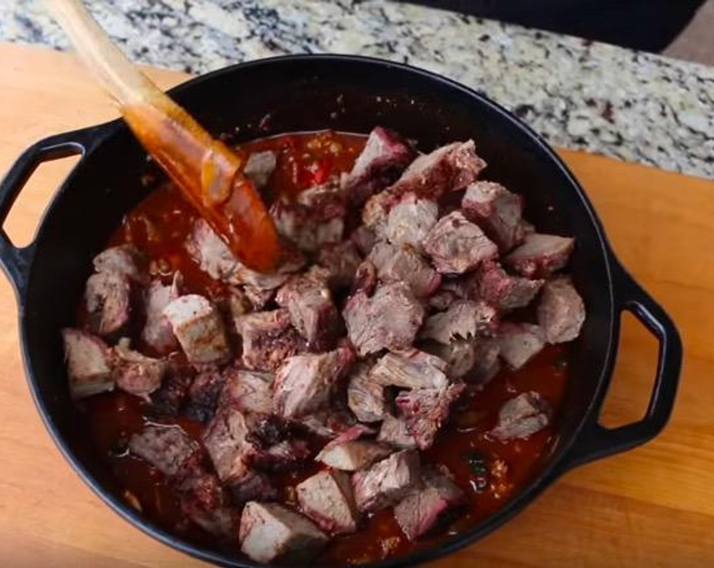 step 6 In a 5-quart iron pot, add chopped grilled vegetables, Canned Diced Tomatoes (3 cups), chuck roast, Spicy Hot Breakfast Sausage (1 lb), Chipotle Peppers in Adobo Sauce (3), Garlic (3 cloves), and Chili Seasoning. Stir to combine.