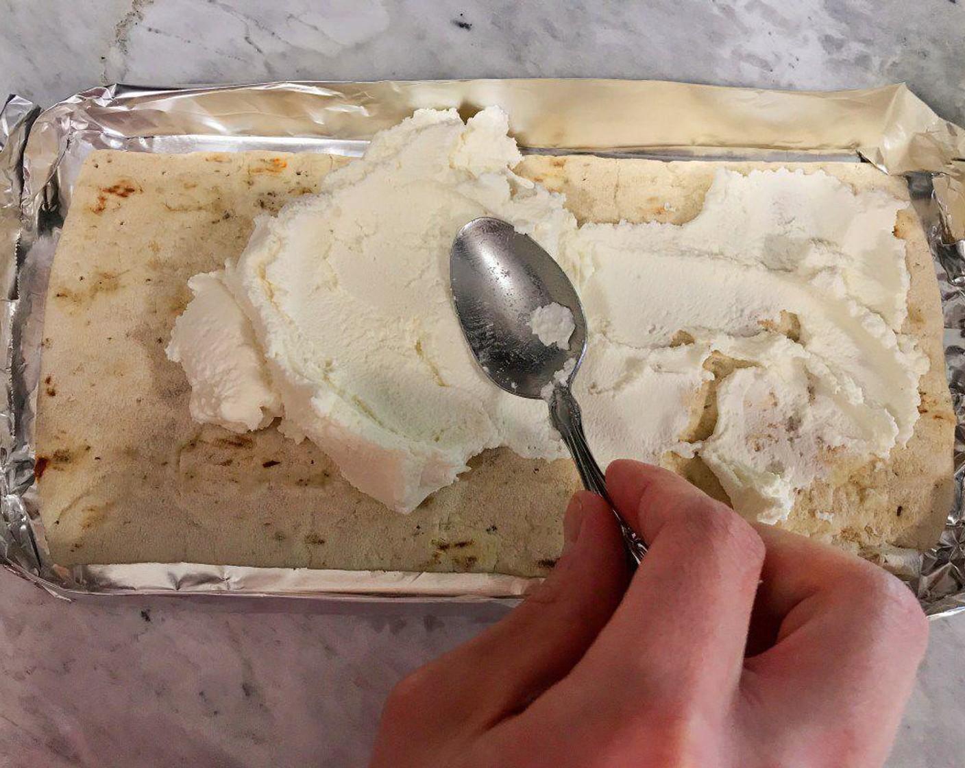 step 6 Spread the Ricotta Cheese (4 Tbsp) evenly on the flatbread.