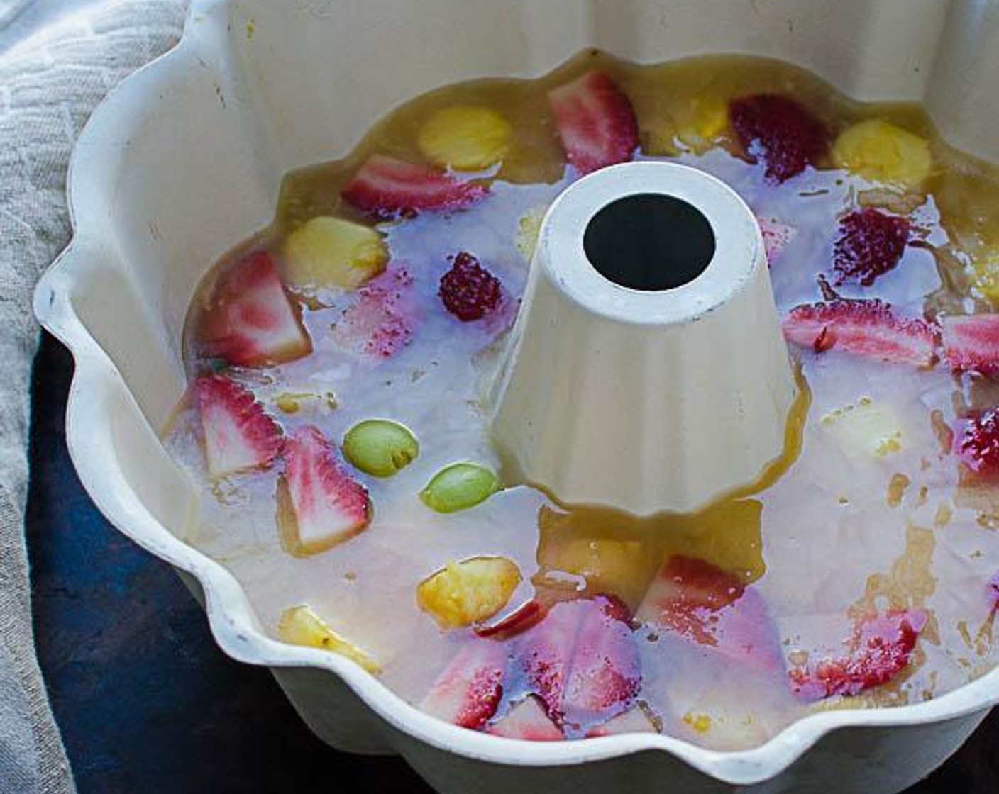 step 4 In a tube pan or bundt pan, scatter the Pineapples (2 cups) evenly and pour the Pineapple Juice (2 cups) over to cover the fruit. Place the pan in the freezer and chill until solid, several hours or overnight.