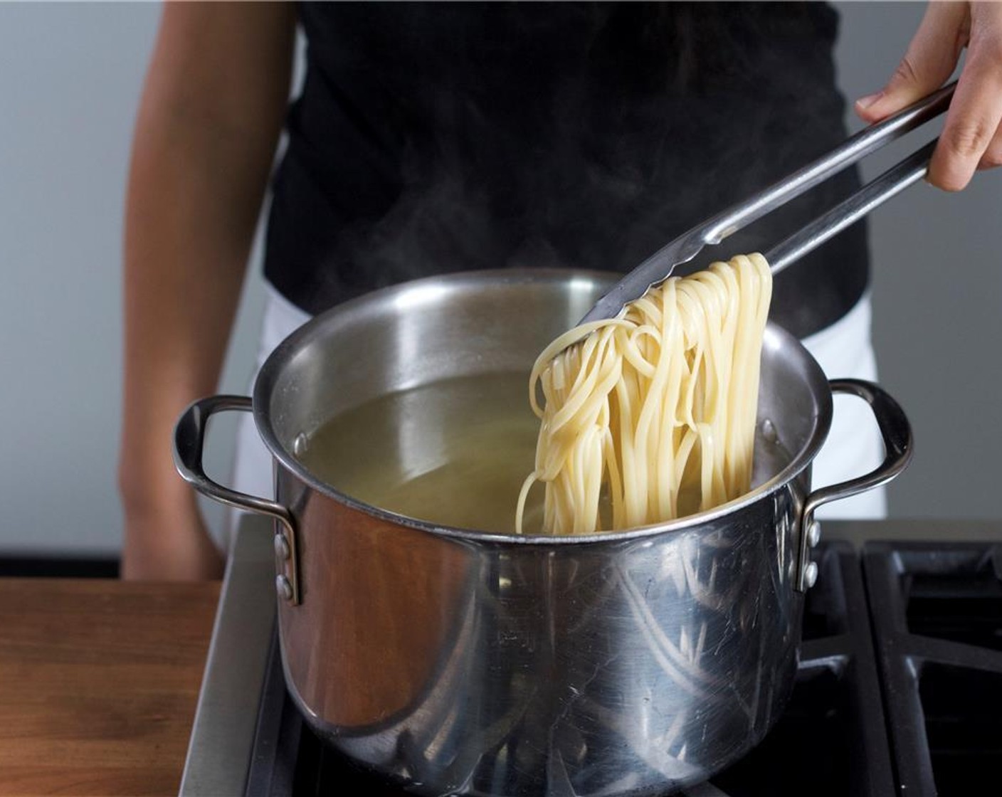 step 4 After two minutes of cooking, continue to separate the noodles with tongs every minute to prevent the noodles from sticking. Drain pasta in a colander and return to large saucepan. Toss with one tablespoon of olive oil to avoid sticking.