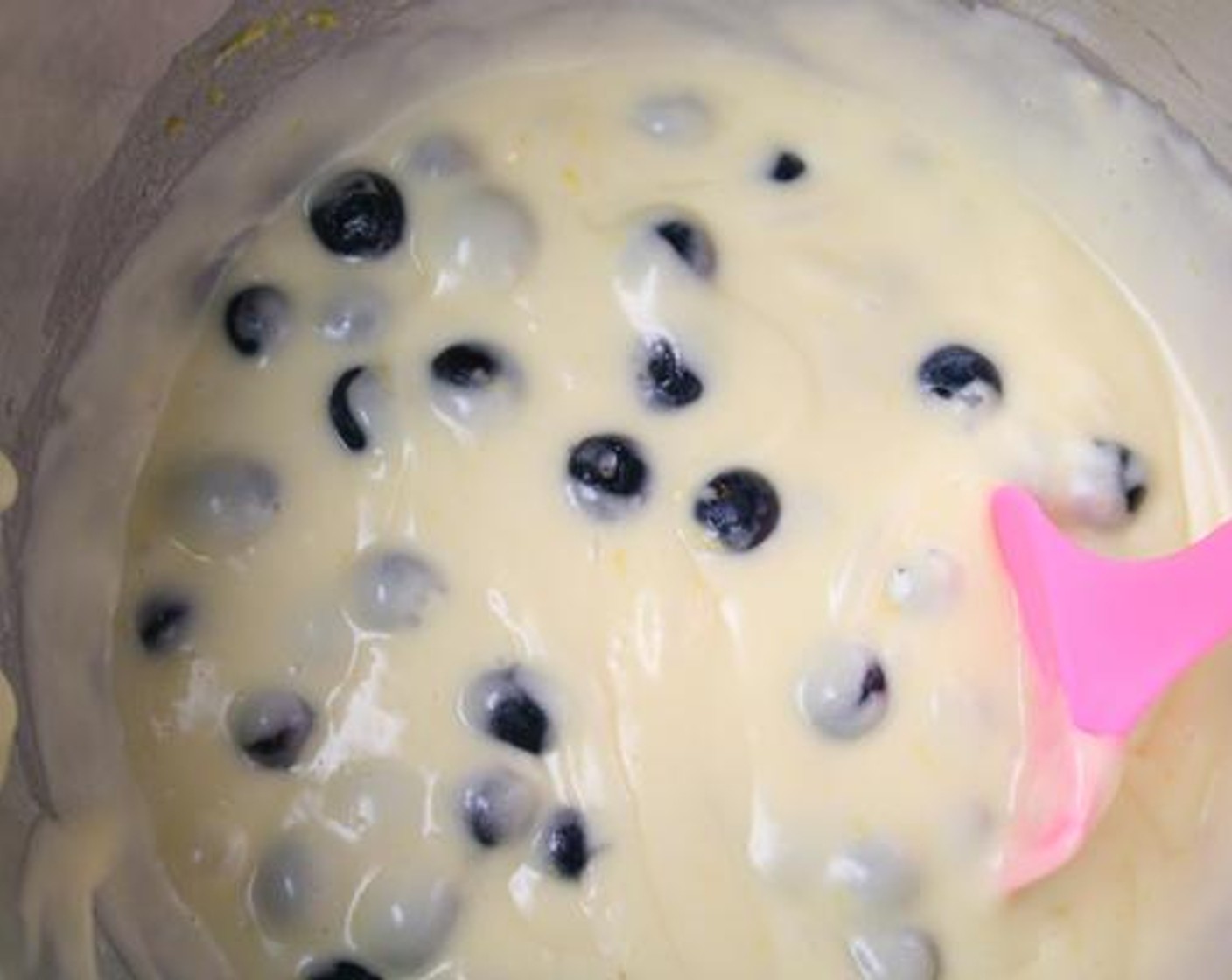 step 3 Prepare Yellow Cake Mix (1 box) according to package instructions. Fold in zest of the Lemon (1). Stir in remaining blueberries.
