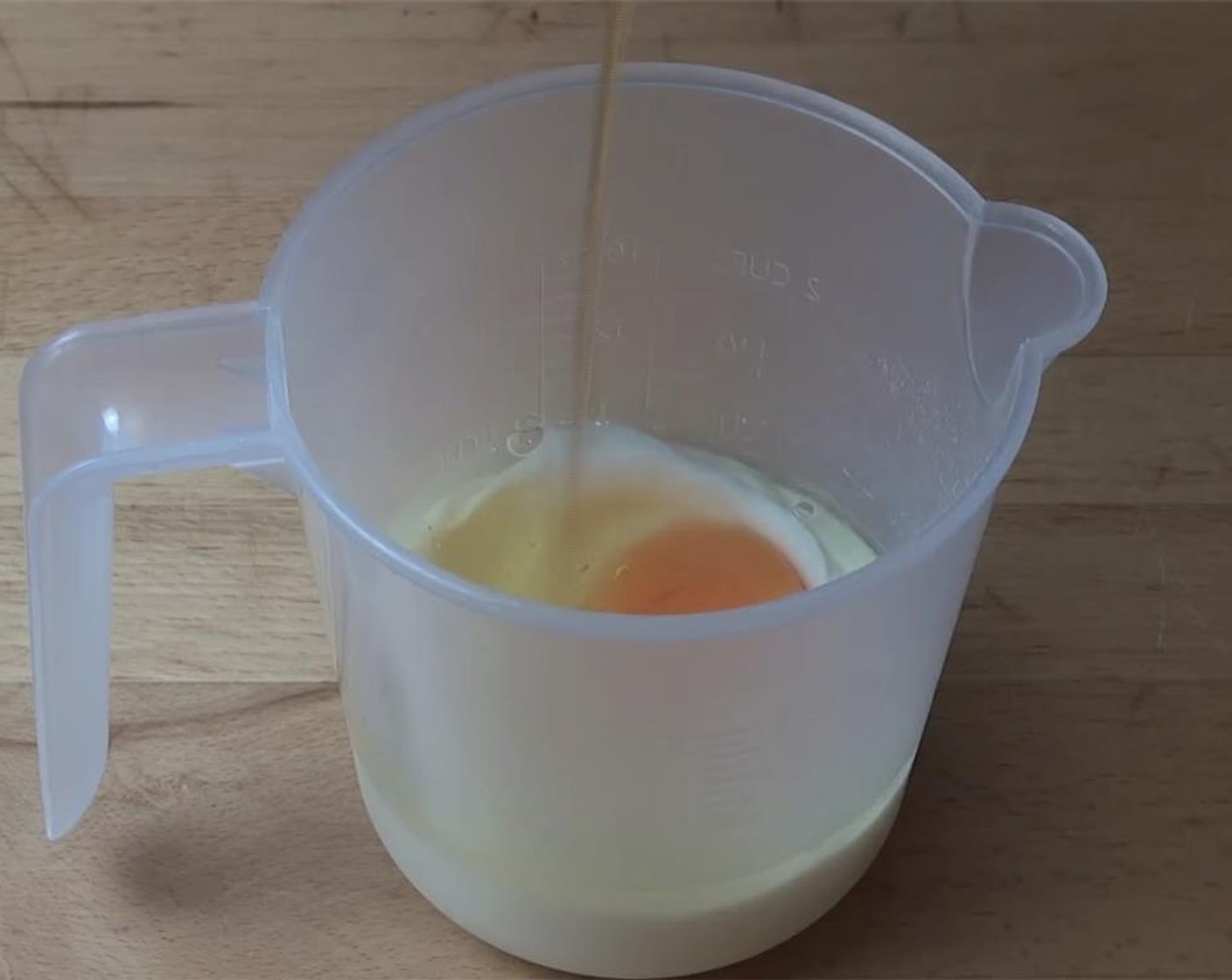 step 2 In a measuring cup, combine Low Fat Vanilla Yogurt (1/2 cup), Egg (1) and Vanilla Extract (1 tsp).