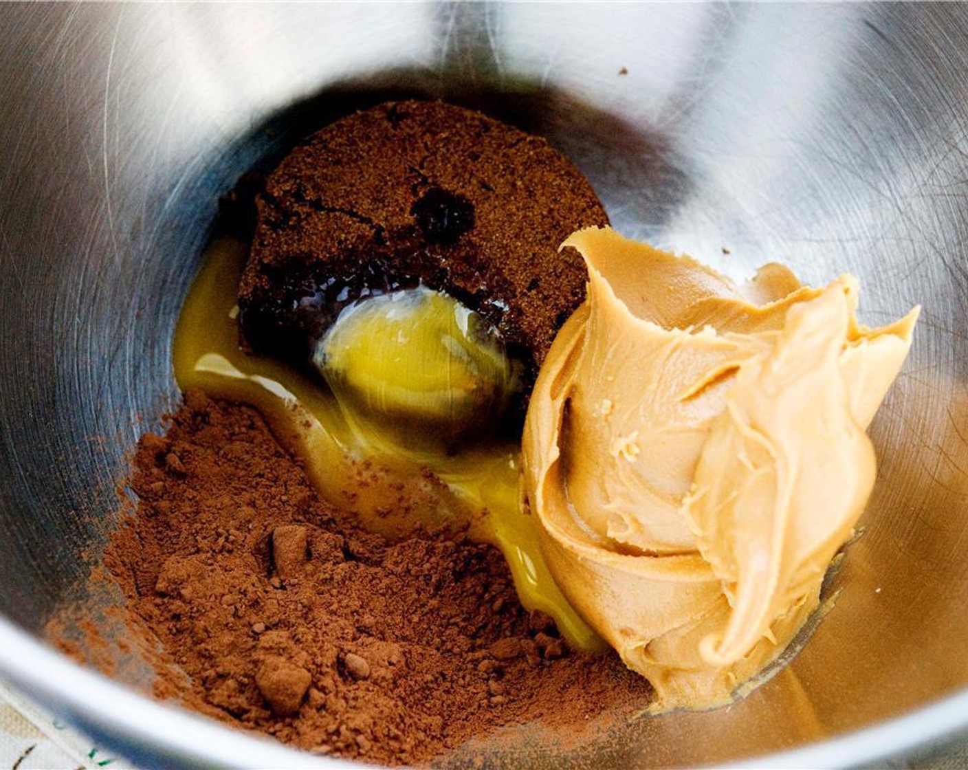 step 1 In the bowl of your electric mixer, combine Creamy Peanut Butter (1 cup), Dark Brown Sugar (1/3 cup), Farmhouse Eggs® Large Brown Egg (1), Unsweetened Cocoa Powder (3 Tbsp), and Baking Powder (1 tsp). Mix until all the ingredients are combined.