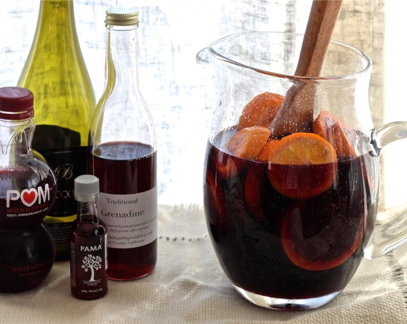 step 3 Combine the Pomegranate Juice (1/2 cup), Natural Pomegranate Grenadine (1/2 cup), Pomegranate Liqueur (1 cup), and Dry Red Wine (3 cups) in a pitcher with the orange slices.