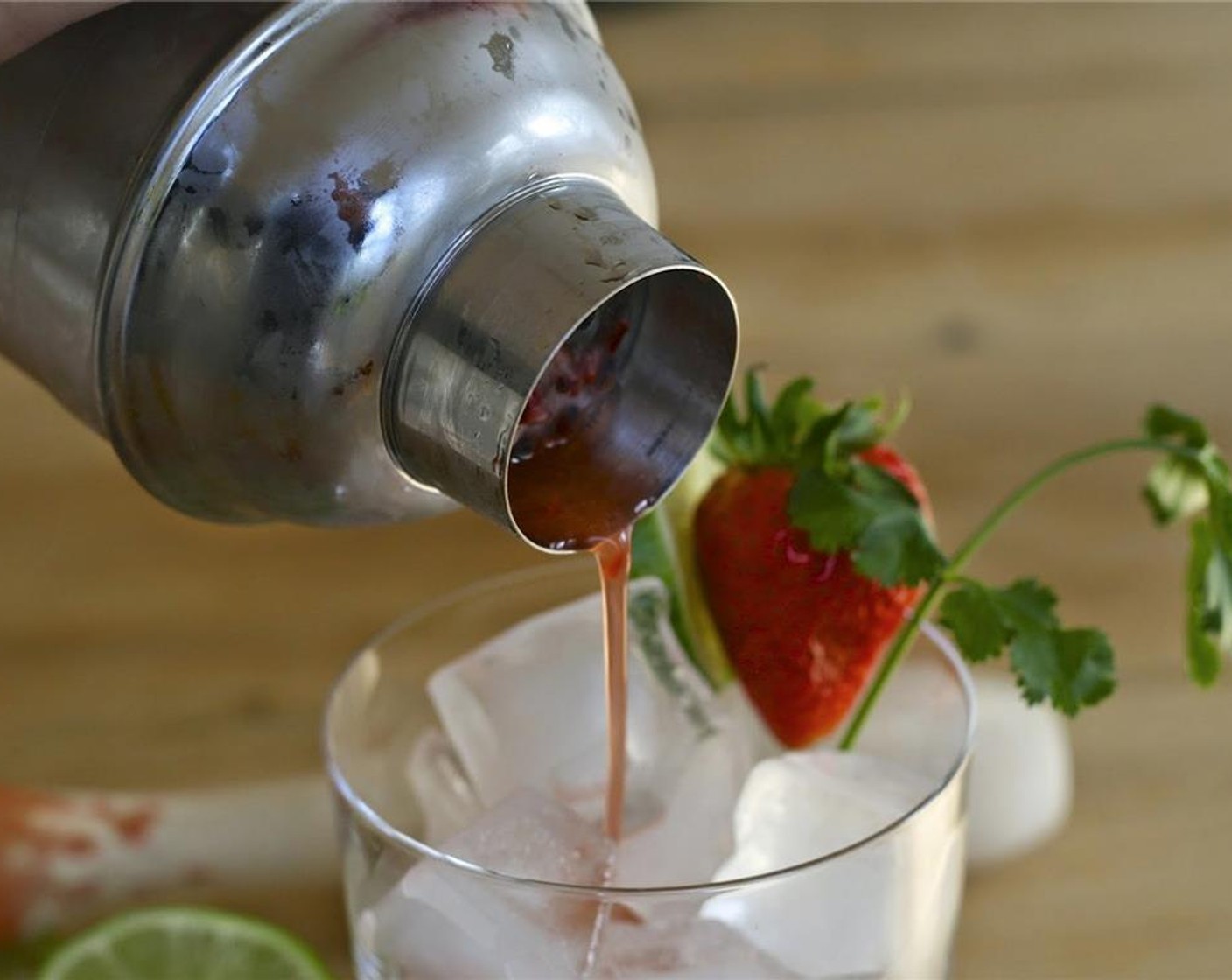 step 3 Strain into a glass filled with ice and garnished with a Fresh Strawberry (1) lime wheel and sprig of cilantro.